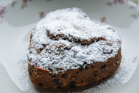 a small cake in heart shape covered with powdered sugar