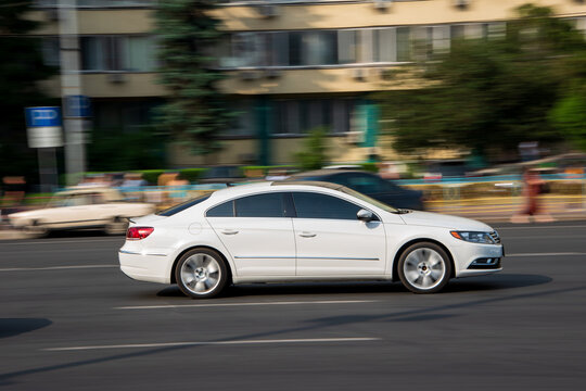 Ukraine, Kyiv - 16 Jule 2021: White Volkswagen Passat CC car moving on the street. Editorial