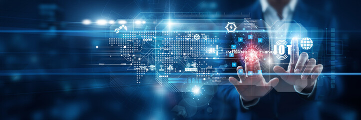 Technology specialist touching connected devices on Internet of Things virtual screen, enabling smart monitoring, real-time data collection, automation, and system connectivity.