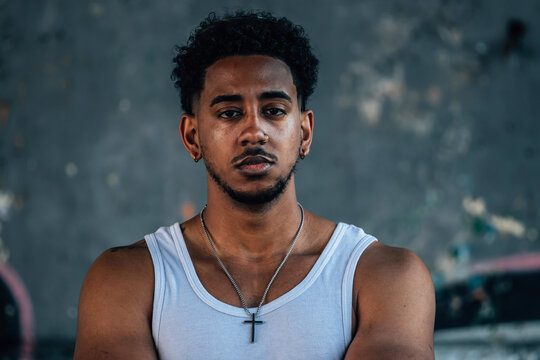 portrait of a young latino man on the street