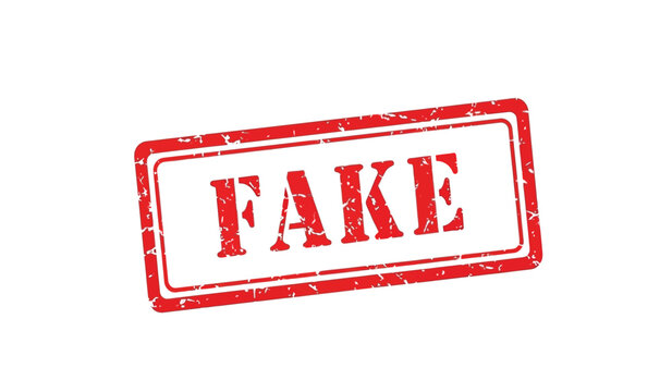 A red rubber stamp with the word fake on a for marking documents as counterfeit or unauthentic