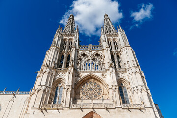 Fototapeta premium Burgos Cathedral facade against a bright blue sky in Spain