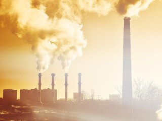 Industry pollution chimneys in sunset city background