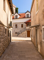 Obraz premium Narrow alleyway leading to modern traditional building in Trebinje, Bosnia and Herzegovina.