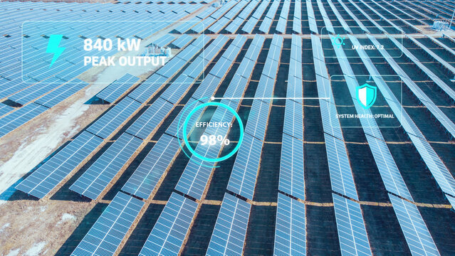 Aerial view of a smart solar farm with digital data overlays displaying peak power output, high efficiency, and real-time performance metrics for sustainable energy.