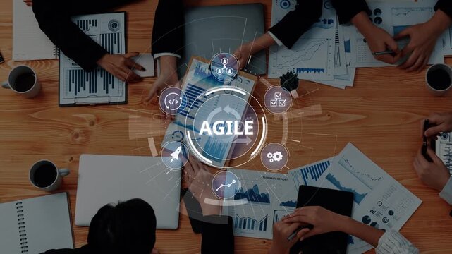 A dynamic business meeting focused on agile methodology showcases teamwork, data analysis, and strategic planning in a modern office setting. Ideal for corporate use. Raster