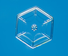 Natural snowflake crystal in blue background
