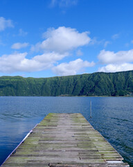 Obraz premium Wooden pier on a calm volcanic lake, Azores, Portugal 