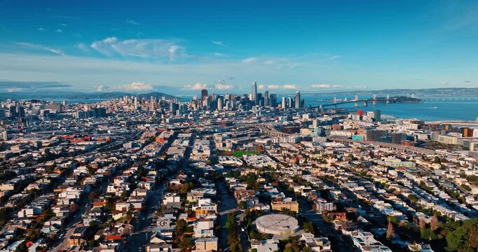 Flight over green urban landscape with lots of lush greenery. Approaching San Francisco downtown, California, USA with high-rise architecture.