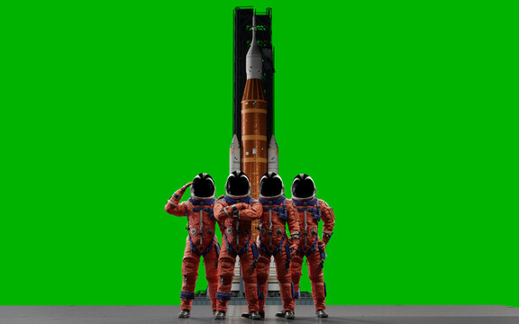 The four-person crew of the Artemis II mission stands ready in their orange OCSS suits in front of the Space Launch System rocket, set against a green screen background for easy compositing