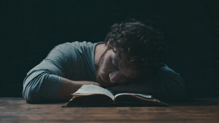 Obraz premium Man Asleep on Open Book at Table