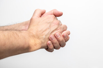 Hand pain, close-up of male hands on a white background
