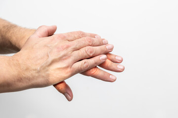 Hand pain, close-up of male hands on a white background
