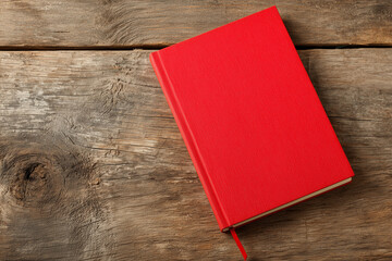 Fototapeta premium A Red Notebook on a Wooden Surface, Note Taking