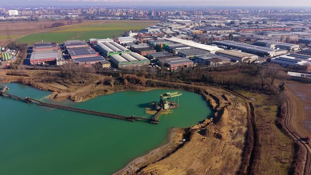 Aerial view of industrial area and sand quarry lake