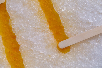 Maple syrup hardening on fresh snow to create maple taffy