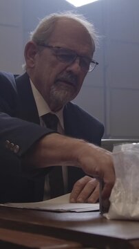 Criminal Trial lawyer in court pointing to notes - modern court room scene