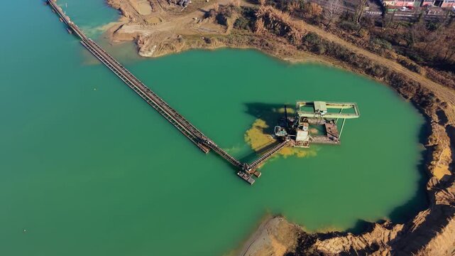 Aerial view of industrial sand quarry and dredging equipment