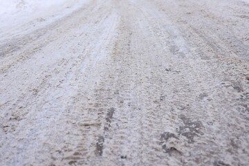 Obraz premium Tire tracks on snowy road outdoors, closeup