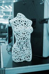 Art model female body printed on 3D printer from molten plastic. Object created on 3D printer. Form printed on 3D printer from blue plastic. Concept 3D printing technology. Additive FDM technologies