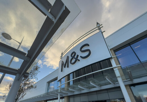 Newcastle-under-Lyme, Staffordshire-united kingdom March, 09, 2025 M&S Storefront Exterior Signage At Modern Shopping Centre With Glass Windows And Skyline Reflection