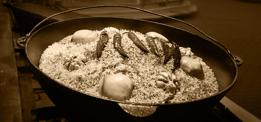 Aromatic pilaf is fried in a cauldron