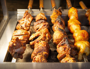 A ruddy kebab is being grilled on a barbecue
