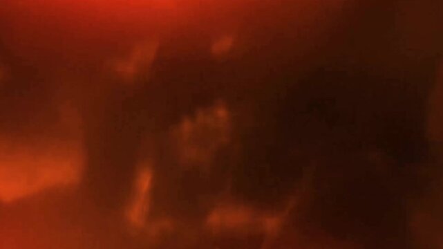 Person surrounded by dark smoke and flames