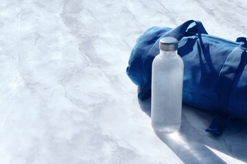 outdoor adventure gear, neat hiking setup with rolled lightweight backpack straps and a water bottle oozing condensation on a white marble surface, softly illuminated