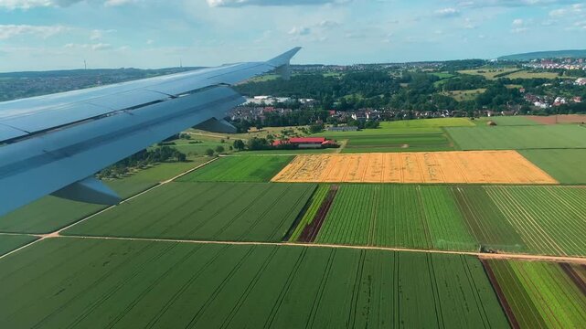 Airplane Window View Over Fields and Cities During Landing Approach