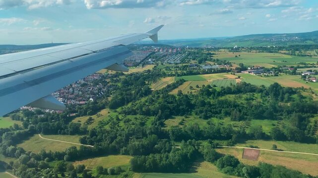 Airplane Window View Over Fields and Cities During Landing Approach