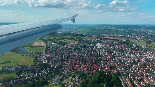 Airplane Window View Over Fields and Cities During Landing Approach