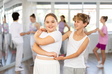 Fototapeta premium Couple boy and girl rehearsing pair waltz dance in studio