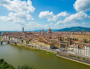 Fototapeta premium Aerial view of Florence Duomo cathedral dominating the old town, highlighting Renaissance buildings and dense rooftops on a bright summer day in Florence, Italy