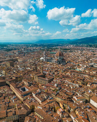 Obraz premium Aerial view of Florence Duomo cathedral dominating the old town, highlighting Renaissance buildings and dense rooftops on a bright summer day in Florence, Italy