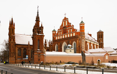 Fototapeta premium Vilnius, Lithuania. View of roman catholic church of St. Anne and Church of St. Francis and St. Bernard In Old Town in winter day
