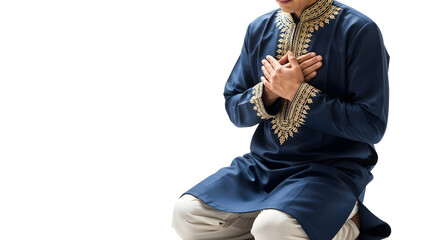 Naklejka premium Man in Traditional Blue Attire with Gold Embroidery Kneeling in Prayer or Meditation, Expressing Spirituality, Devotion, and Cultural Reverence on White Background