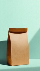 Brown Paper Lunch Bag Standing on Textured Light Blue Surface with Shadow Casting from Window in Studio with Bright Overhead Lighting