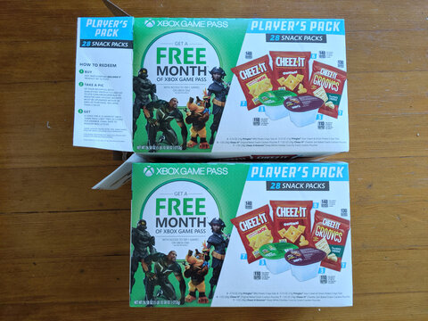 Free month of Xbox Game Pass promotion with snack packs featuring variety of items