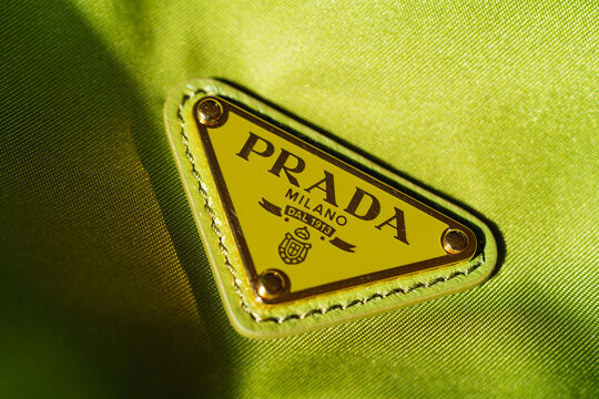 Prada Milano metal logo plaque on a textured green handbag