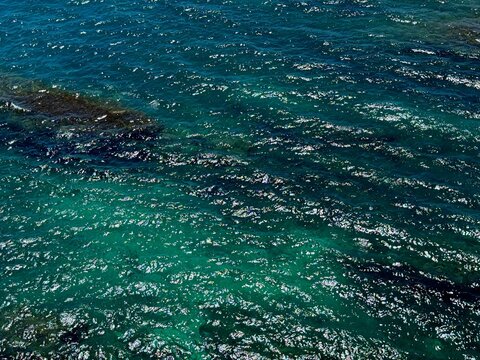 Glittering blue turquoise sea water surface aerial view.