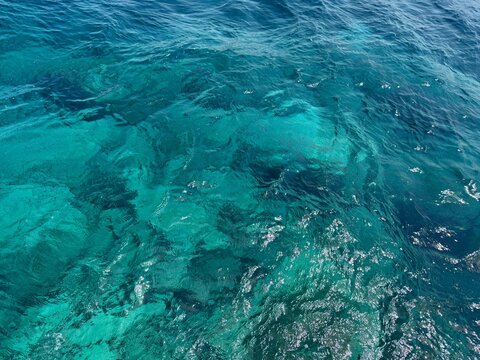 Blue azure sea waves shiny clear surface.