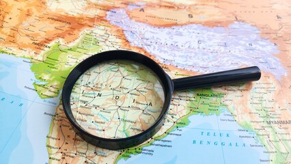 view of India, officially the Republic of India, is a country in South Asia on a geographical map of ASIA, seen using a magnifying glass