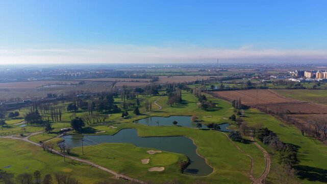 Aerial view of a golf course with ponds and greens