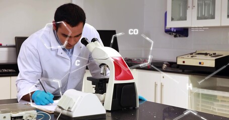 Researcher in white lab coat and blue gloves using microscope, taking notes at lab with overlays
