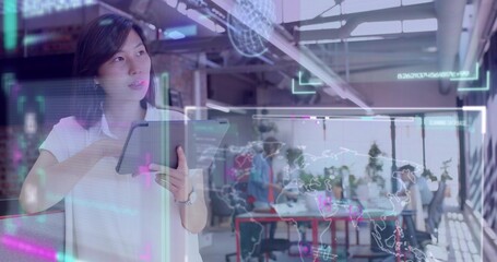 Showing Korean in white blouse, holding tablet and viewing translucent map UI in office, copy space © vectorfusionart