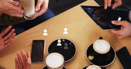 Circling hands discussing over lattes on black saucers, tapping tablet and smartphone