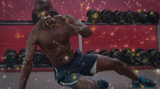 Shirtless man starting plank, shifting into spiderman sitting up, training, gold bokeh over scene