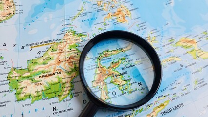 view of Sulawesi, also known as Celebes, is an island in Indonesia. One of the four Greater Sunda Islands, on a geographical map of Asia, seen using a magnifying glass