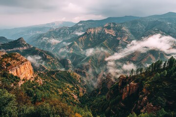 Lush Green Mountains Under Cloudy Sky with Mist and Warm Sunlight